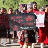 A young girl marches in rememberance of stolen indigenous sisters in Phoenix May 5, 2022.