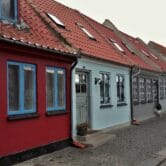 Row of old-school houses in red, blue and grey colors