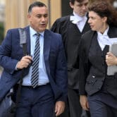 John Barilaro walks to court with lawyers in Sydney.