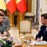 Ukrainian President Volodymyr Zelenskyy speaks with French President Emmanuel Macron