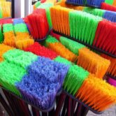 A number of colorful brooms.