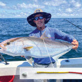 A fisherman holds a greater amberjack
