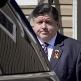 Illinois Gov. J.B. Pritzker leaves a funeral home in Waukegan