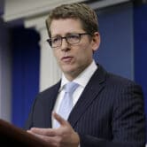 Jay Carney gestures as he speaks during a news briefing at the White House.