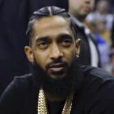 Nipsey Hussle attends an NBA game in Oakland.
