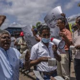 People chant and carry signs during a protest in Sri Lanka.