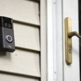 A Ring doorbell camera is seen installed outside a home.