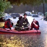 Firefighters rescue people during flooding in St. Louis.