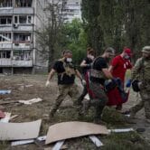 Paramedics carry a body in Kharkiv, Ukraine