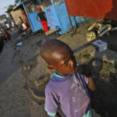 A young boy stands in the streets of Monrovia, Liberia.