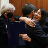 Patricia Guerrero hugs another justice during her confirmation hearing.