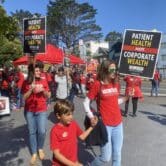Workers striking outside Kaiser in red shirts