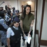 Brittney Griner is escorted to a Russian courtroom.