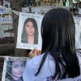 An activist in Mexico City tidies up an anti-monument to the victims of enforced disappearances