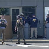 FBI officials gather outside the FBI building in Cincinnati.