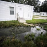 Fetid water stands outside a mobile home in Alabama.