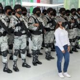 A citizen poses with Mexican National Guard troops