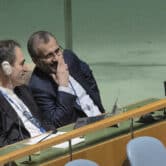 Iranian delegates look at each other during a United Nations conference.