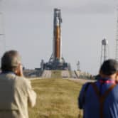 People observe a NASA rocket at the Kennedy Space Center.