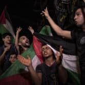 Palestinians celebrate a cease-fire agreement in Gaza City.