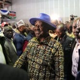 Kenyan presidential candidate Raila Odinga walks through a crowd.