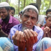 Rohingya refugees cry while praying during a gathering in Bangladesh.