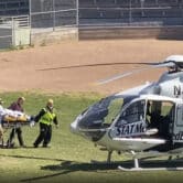Author Salman Rushdie is taken on a stretcher to a helicopter.