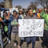 Women protest outside a court in South Africa.