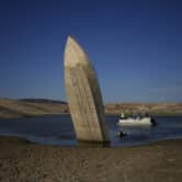 A formerly sunken boat sits upright in Lake Mead.