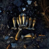 Burned mortar shells lie on the ground in Ukraine.