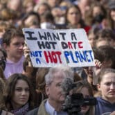 A sign reading "I want a hot date, not a hot planet" is held up during a demonstration.