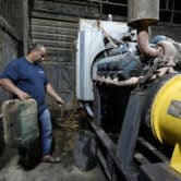 A man fuels a generator in Baghdad, Iraq.