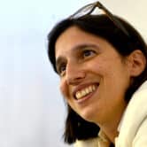Italian politician Elly Schlein smiles during an interview.