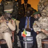 Mali and Guinea's leaders speak during a military parade in Bamako.