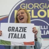 Brothers of Italy leader Giorgia Meloni holds a placard reading "Thank you Italy."