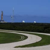 A NASA rocket stands on a launch pad.