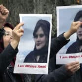 Exiled Iranians hold signs outside of Iran's embassy in Berlin.