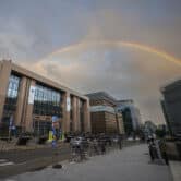 A rainbow appears above buildings in Brussels.