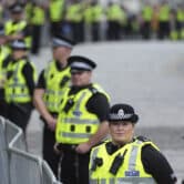 Police officers stand in Scotland.