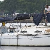 A man prepares his sailboat for Hurricane Ian