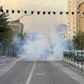 Tear gas is thrown by the police during a protest in Iran.