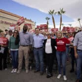 Adam Laxalt poses for a photo with supporters during a rally in Las Vegas.
