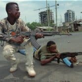 Liberian fighters shoot their way through downtown Monrovia.