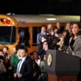 Kamala Harris speaks in front of a school bus at an event in Seattle.