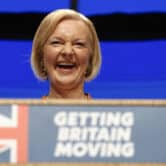 Liz Truss laughs during her speech at the Conservative Party conference in England.