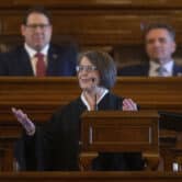 Marla Luckert addresses the legislative and executive branches during a speech at the Kansas Statehouse.