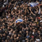 Mourners carry the bodies of Palestinians who were killed during an Israeli raid.