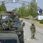 A Russian military convoy is seen on a road in Ukraine.