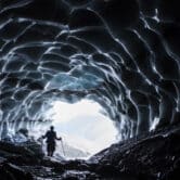 A man stands in a cave at the Sardona glacier,