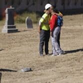 People hug at the site of the excavation searching for victims of the 1921 Tulsa Race Massacre.